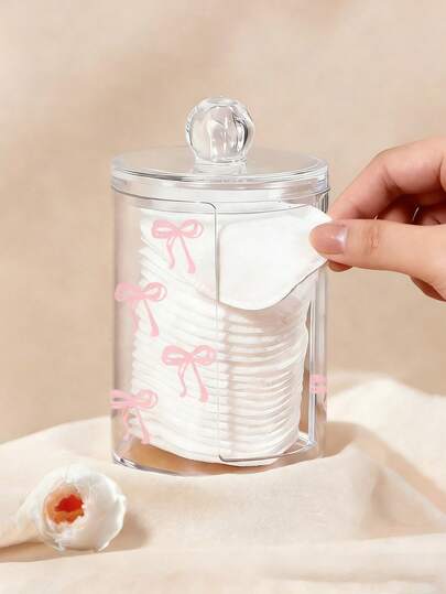 粉色蝴蝶结透明化妆品收纳盒，大容量圆柱形储物盒，棉签收纳盒，卸妆棉片分发盒，带盖卸妆棉片收纳盒，透明化妆品收纳盒，浴室棉签卸妆棉片收纳盒，可水洗易清洁。适用于收纳眼贴、美妆蛋和清洁海绵。桌面收纳盒。