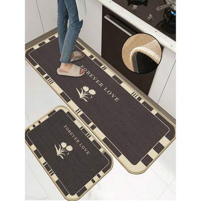 1 tấm thảm bếp bằng cao su mềm, dày 3.5mm, phối màu tương phản trầm giữa nâu đậm và be, nền nâu đậm với dòng chữ "FOREVER LOVE" và hình bóng hoa tulip màu be ở trung tâm, viền xung quanh là họa tiết sọc hình học, thiết kế góc bo tròn, thảm thấm hút tốt, tối giản và thanh lịch cho nhà bếp.