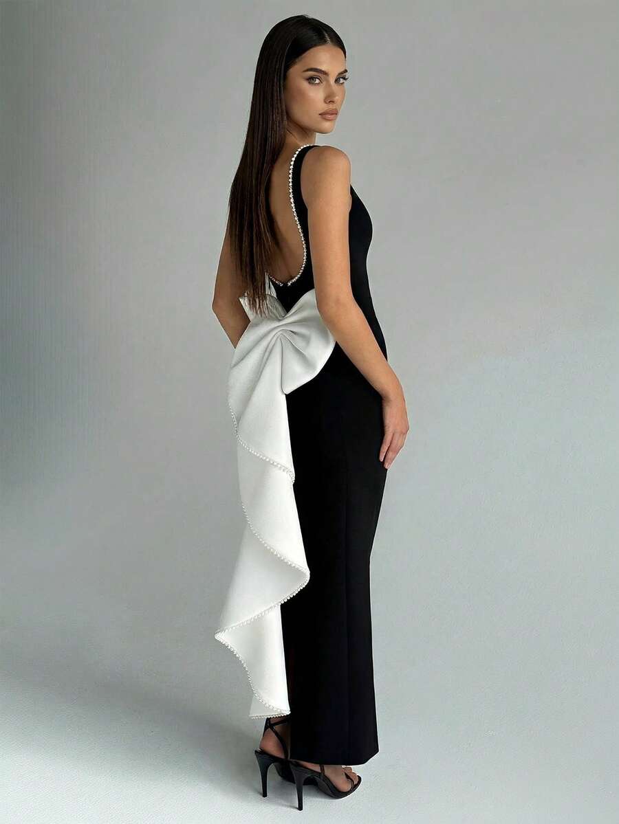 黑白撞色无袖收腰连衣裙，背部饰有仿珍珠蝴蝶结，修身时尚，适合春日晚宴、婚礼和派对穿着。 - 黑與白 - 查看 1