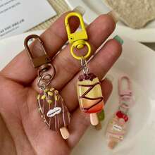 这款坚果冰棒钥匙扣设计清新逼真，质感细腻，造型可爱又治愈，宛如甜点般诱人。搭扣结实顺滑，既可作钥匙扣，也可作包包挂饰，用途广泛，充满时尚气息。 - 彩色 - 查看 2