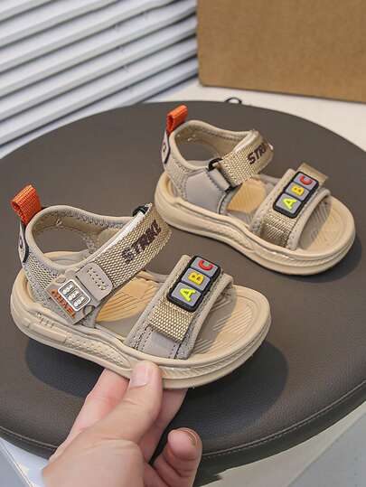 1 Pair Baby Sandals, Hook And Loop Convenient Design For Easy On/Off, Self-Wear, Adjustable. Colorful ABC Letter Decor On Upper For Playful Identification, Kids Love Wearing Them. Mesh Splicing Upper, Breathable And Non-Stuffy. Anti-Slip Thick Sole, Safer For Running And Playing. Khaki Tone, Easy To Clean, Suitable For Shorts, Sportswear, From Kindergarten To Playground