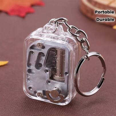 1 机械音乐盒钥匙扣 - 手摇弹簧式锌合金和 ABS 透明设计，随机旋律，便携式复古礼物，迷你音乐盒，适合户外休闲使用，塑料外壳。
