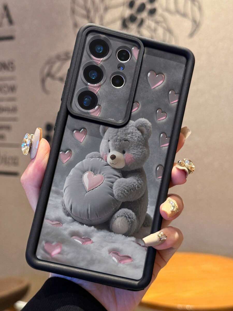 Funda protectora de teléfono de silicona con patrón de corazón y peluche gris de 1 pieza que sostiene un oso de peluche con patrón de corazón, parachoques grueso y suave para Android Galaxy A55/A15/S21,S22,S23 FE,S24 Plus,25 Ultra, SMART 8 Pro,Honor,One Plus,versión internacional, no la versión nacional, regalo de cumpleaños de primavera - Negro - Ver 1