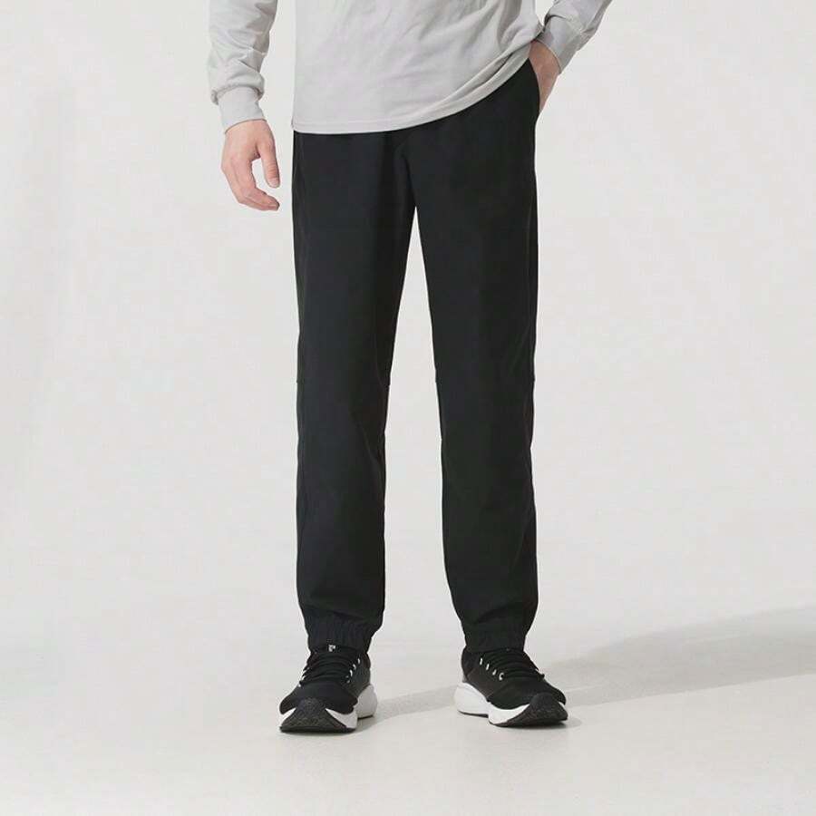 Under Armour Pantalones jogger tejidos Icon, pantalones de entrenamiento de ajuste holgado con cordón en la cintura, 6000663 - Negro - Ver 1