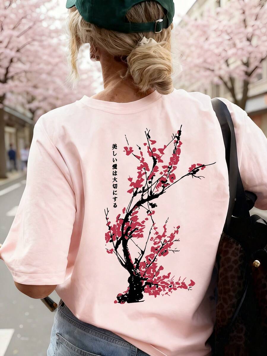 女款粉色圓領梅花印花T恤，寬鬆休閒風，適合日常穿搭與夏季度假