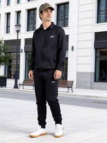 Conjunto Reebok Tracksuit Vector para Hombre Chamarra Cierre Completo y Pantalón Deportivo de Ajuste Regular Tejido Suave Logotipo Vector Minimalista Calentamientos Entrenamiento y Casual - Negro - Ver 4