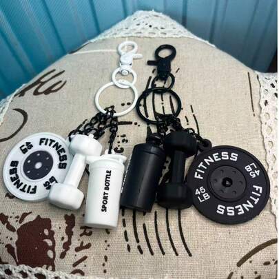 The Black-Gold Dumbbells And Barbell Weights Have Been Transformed Into Stylish Accessories That Serve As Badges Of Honor. With Their Rugged Metal Finish, They Pay Tribute To Every Drop Of Sweat. The Classic Elements Of Strength Combined With Simple Chains Not Only Add A Personal Touch To Keys And Backpacks But Also Serve As A Daily Emblem Of Self-Discipline. Make Every Journey A Silent Declaration Of Your Commitment To Fitness And Aesthetic Living.