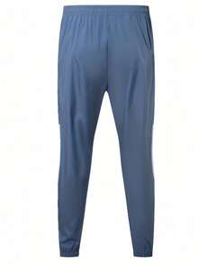 Bộ đồ thể thao nam 2 món phối màu tương phản, bao gồm áo khoác có mũ in họa tiết và quần. - Màu xanh lam - Xem 9