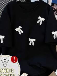 Camiseta de verano holgada con estampado de lazo para mujer, versátil, de cuello redondo y manga corta, agradable al tacto y transpirable, ideal para el uso diario y casual. - Negro - Ver 1