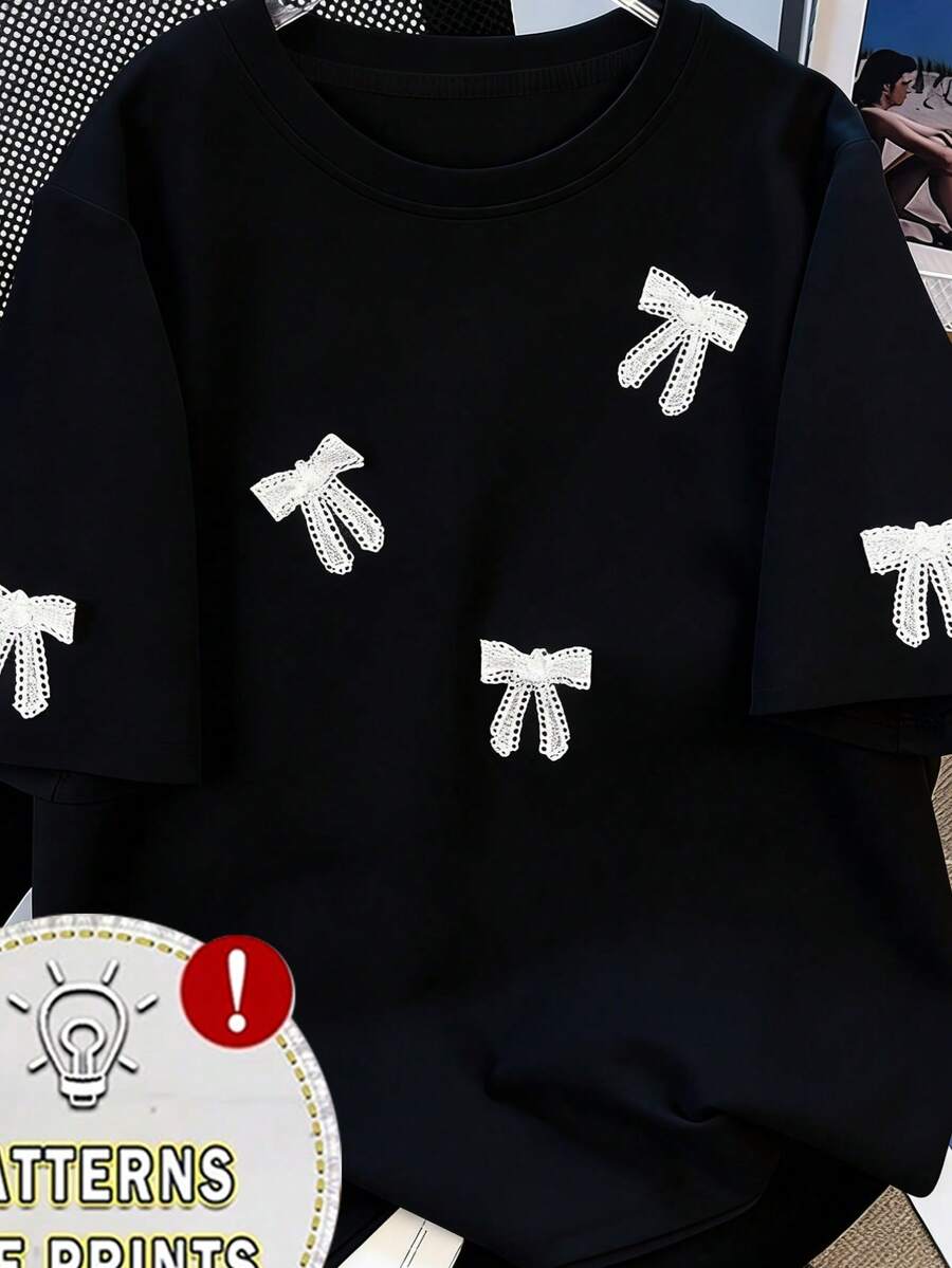 Camiseta de verano holgada con estampado de lazo para mujer, versátil, de cuello redondo y manga corta, agradable al tacto y transpirable, ideal para el uso diario y casual. - Negro - Ver 1