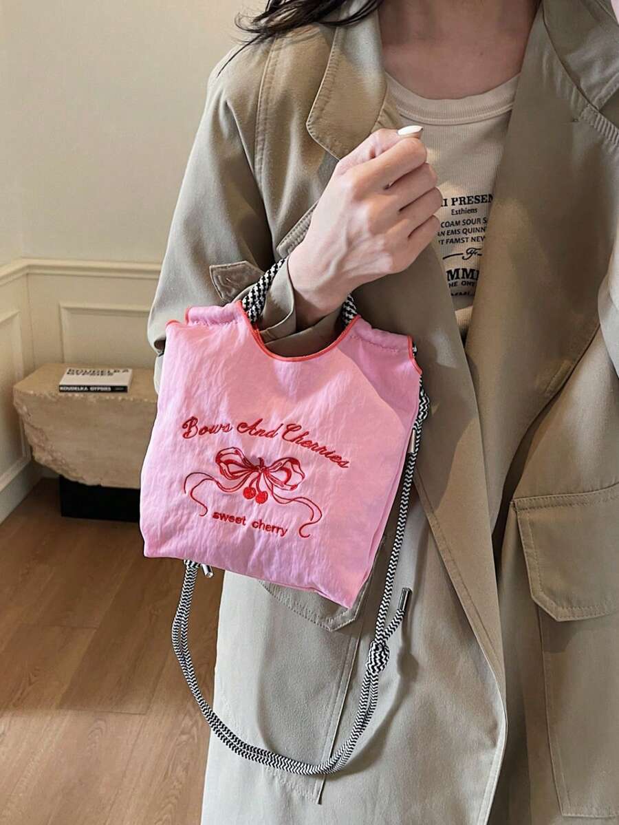 Bolso de tela de nailon con bordado de mariposa, estilo dulce de niña. Bolso de hombro con correa tejida en blanco y negro. - Rosa - Ver 1