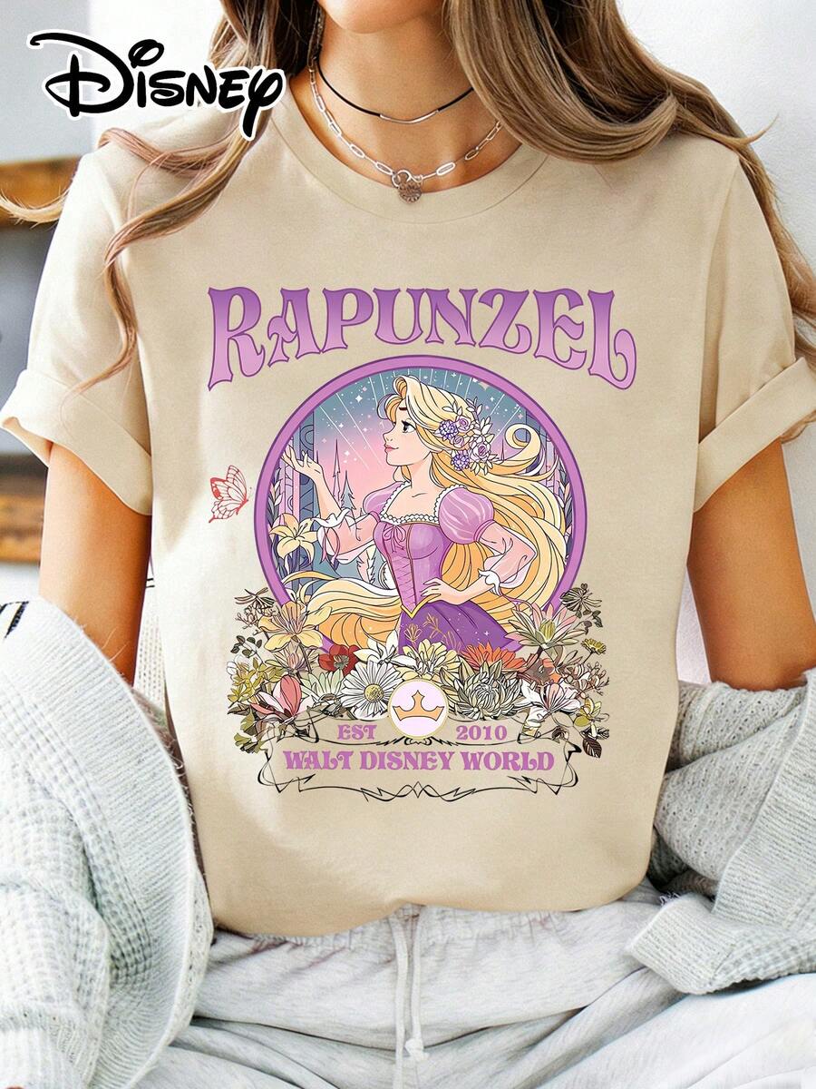 Disney Official Authorization | Women's Street Casual Short-Sleeve T-Shirt. Features Retro Floral Print With Rapunzel (Tangled), Stylish "RAPUNZEL" Lettering, Paired With "WALT DISNEY WORLD Est.2010" Vintage Logo. Made Of Opaque Fabric, Machine Washable, Versatile And Casual, Suitable For Spring And Summer Wear. - Apricot - View 1