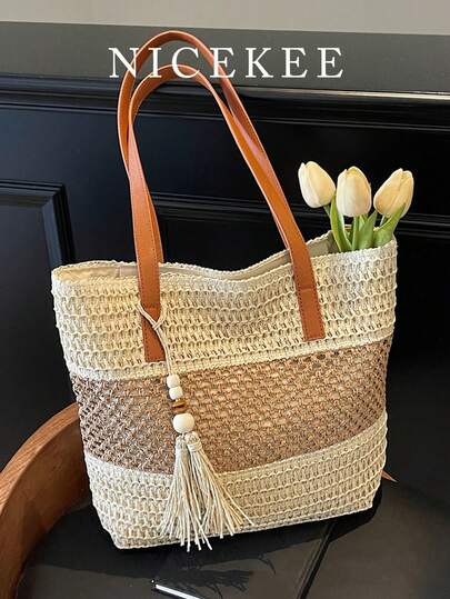 时尚撞色大容量单肩包，简约休闲精致日常腋下包，独特流苏镂空个性化手提包，适合度假海滩购物和派对等场合。