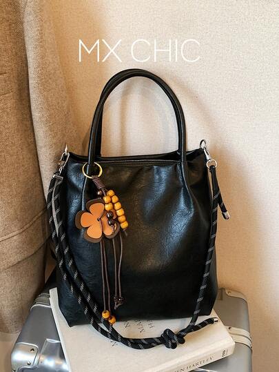 1个女士纯色PU手提包，大容量复古手提包，带花卉吊坠，适合通勤、购物和送礼。