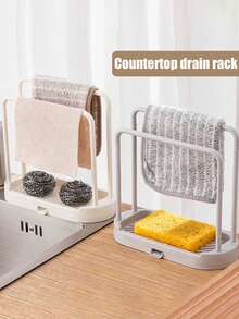 Este estante de almacenamiento para fregadero de cocina es una caja de almacenamiento para encimera que ahorra espacio con una bandeja de drenaje. Es un contenedor de almacenamiento compacto para el fregadero con un diseño de drenaje rápido y una instalación fácil sin necesidad de taladrar. Adecuado para almacenar artículos de cocina y baño como paños de cocina, esponjas, cepillos y jabón. También es adecuado para almacenar esponjas, paños de cocina, fregonas, cepillos, lana de acero y otros artículos de almacenamiento de cocina. Forma parte de un estante y soporte de almacenamiento de cocina. - Ver 11