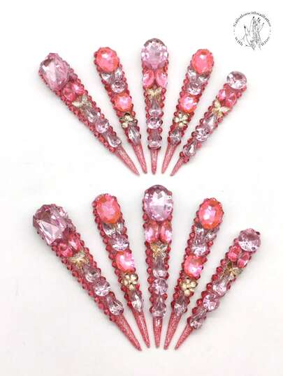 10片纯手工压制美甲贴片，77毫米长，纤细高跟设计，酒红色闪粉覆盖，红色水钻装饰，中心镶嵌小水钻，饰以大水钻，搭配金色蝴蝶饰品和花朵饰品。热情洋溢的美甲贴片，尖头美甲贴片。