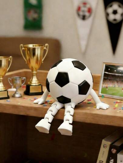 一件足球造型雕塑，适合家居、办公室和花园装饰。这款运动主题装饰品是送给足球迷和爱好者的理想礼物。