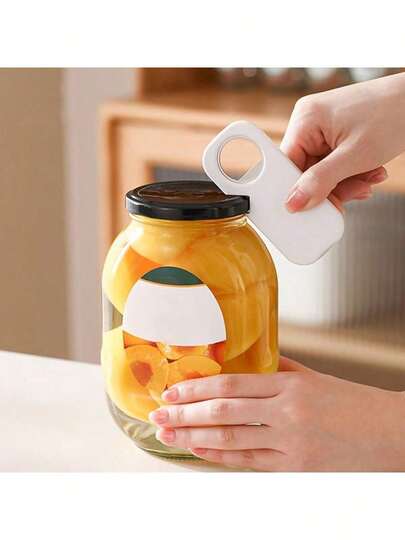 白色ABS塑料开罐器，便携式手动开盖工具，专为老年人设计，轻松打开玻璃瓶真空密封，适用于家庭厨房，是手部力量较弱人士的必备工具，多功能开盖器，可轻松拧开卡住的瓶盖，也适用于餐厅、户外野餐等场合，是厨房的理想配件。