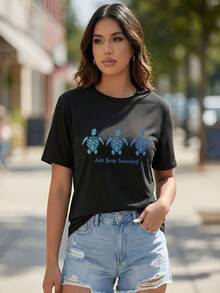 This Women's Must - Have T - Shirt Is A Stylish American - Style Piece. Crafted From High - Quality 100% Pure Cotton Fabric, It Is Not Prone To Pilling And Ensures Comfortable Wear. Weighing 180 Grams, The T - Shirt Is Breathable, Versatile, And Suitable For All Body Types. It Has A White Base, Short Sleeves, And A Round Neck. On The Front, There Are Three Sea Turtles In Teal And Blue Hues, With The Text "Just Keep Swimming" Below The Turtles. The T - Shirt Won't Fade Even After Multiple Washes, Making It An Ideal Choice As A Back - To - School Gift, Graduation Present, Or A Valentine's Day Surprise For Your Partner. - 黑色 - 查看 2