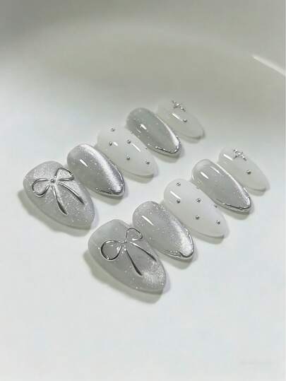 10片手工美甲贴纸，可拆卸亚克力椭圆形美甲贴，可爱简约设计，包含银色猫眼、蝴蝶结、乳白色波点、手绘法式美甲、银色星星等图案，适合新年、情人节、派对、春季、夏季、秋季、冬季等各种场合，是女孩必备的化妆配件。