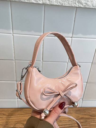 2026 春季新款时尚甜美蝴蝶结简约纯色新月形单肩手提包（女士款）