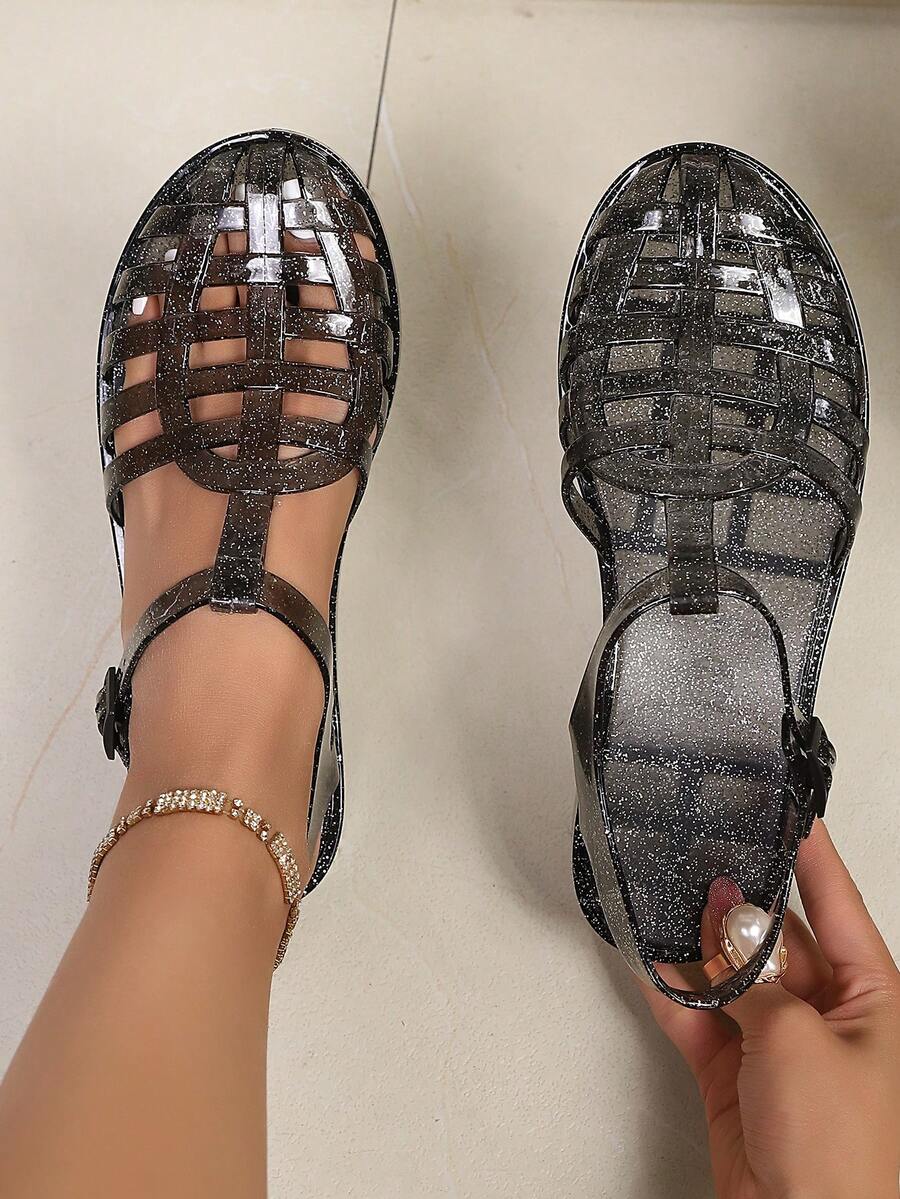 夏季新款女士闪亮镂空罗马果冻鞋，复古编织镂空设计，具有自清洁功能，透明、亮黑色、玫瑰金等多种颜色可选，适合海滩度假、日常通勤、派对等场合，可搭配牛仔裤、性感服饰，是打造吸睛夏季造型的必备单品。 - 黑色 - 查看 1