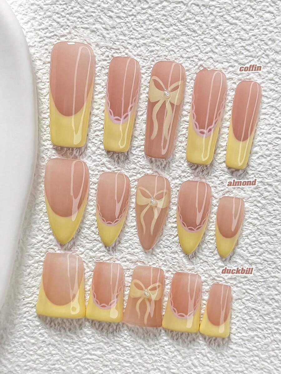 10件套甜美夏日风亚克力美甲套装，包含手绘黄色蝴蝶结、黄色蕾丝法式甲片，可爱甜美风格，附赠美甲工具（1个果冻贴纸+1个指甲锉），3种甲型可选：杏仁形、鸭嘴形、棺材形，适合日常、派对、拍照、春夏、外出等场合。 - 彩色 - 查看 1