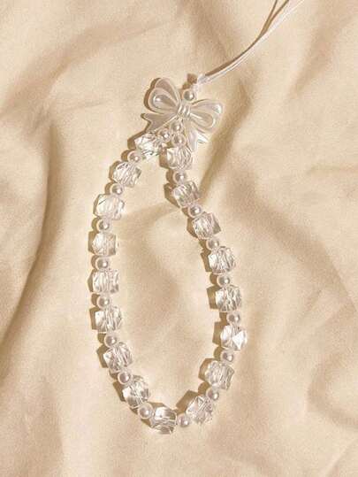 极简白色蝴蝶结手机壳挂绳吊坠，短款便捷挂绳，适用于所有手机和相机，可斜挎、手持或戴在手腕上，防丢防摔，是送给母亲、家人和朋友的理想生日、节日礼物，也是手机挂饰和手机挂绳的绝佳选择。