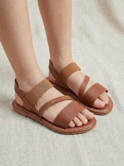 1双儿童夏季新款凉鞋，简约纯色交叉绑带，松紧带套穿式，适合海滩和日常穿着