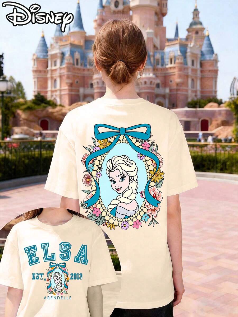This Disney-Licensed Women's Summer Cotton T-Shirt Features An Image Of Elsa From Disney's Frozen Animated Film On The Front, Themed Around Disney's 2026 Journey, Creating A Lively Party Vibe. Perfect For Taking Photos At Disneyland, As A Travel Souvenir, Or For Everyday Casual Wear. As Part Of A Disney Family Travel Set, It Also Makes An Ideal Valentine's Day Gift For Friends And Family. This Women's T-Shirt Features A New Spring Design, Is Comfortable Against The Skin, And Suitable For Outdoor Wear. - Apricot - View 1