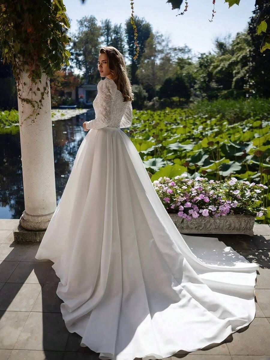 French Country-Inspired Long Sleeve Lace And Satin Wedding Gown With Subtle V Square Neck, Fitted Waist Belt, Full A-Line Skirt And Flowing Train, Elegant Bridal Dress For Garden Ceremony, Estate Wedding, Christmas, Halloween, Prom, Birthday Party & Special Occasions - This Timeless And Sophisticated Gown Is Ideal For The Bride's Wedding, Vow Renewal, Or Engagement Celebration, While Its Versatile And Refined Style Also Makes It A Stunning Choice For A Wide Array Of Formal And Festive Occasions Including Prom, Homecoming, Cocktail Parties, Anniversary Dinners, Birthday Galas, Graduation Ceremonies, Vacation Events, And Black-Tie Galas; Expertly Crafted With Clean Lines And Luxurious Fabric For All-Season Comfort And A Flattering Fit, This Dress Effortlessly Combines Understated Elegance With Dramatic Impact, Ensuring A Memorable And Photogenic Presence At Any Special Celebration. - trắng - Xem 1