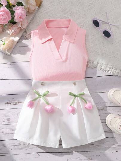 Bộ 2 món thời trang gồm áo dệt kim không tay cổ bẻ màu trơn và quần short ống rộng màu trơn có cúc và nơ trang trí hoa, thích hợp mặc hàng ngày cho các bạn nữ tuổi teen vào mùa hè.