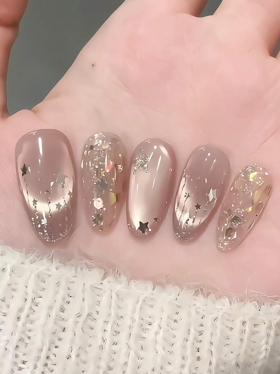 10片手工美甲贴纸，粉色猫眼图案，饰以银色星星和金色箔片，椭圆形，适合春夏婚礼、情人节、音乐节等场合，包含胶水和指甲锉，DIY美甲用品