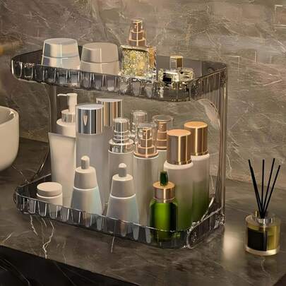 1 ชิ้น ชั้นวางเครื่องสำอางอะคริลิกใสสองชั้นสุดหรู, ชั้นวางของจัดระเบียบเครื่องสำอางและผลิตภัณฑ์ดูแลผิวสำหรับห้องน้ำ ทำจากอะคริลิกใสที่มีพื้นผิวเป็นคลื่นเพื่อรูปลักษณ์ระดับพรีเมียม โครงสร้างสองชั้นสามารถเก็บผลิตภัณฑ์ดูแลผิว, น้ำหอม, เครื่องสำอาง และผลิตภัณฑ์ความงามอื่นๆ ได้ โปร่งใสและมองเห็นได้, มั่นคงและไม่ลื่น, กันฝุ่นและความชื้นเพื่อรักษาความสะอาดและสุขอนามัยของสิ่งของ เหมาะสำหรับเคาน์เตอร์ห้องน้ำ, โต๊ะเครื่องแป้ง และสถานการณ์อื่นๆ