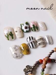 10片装按压式美甲贴片，白色花朵绿色镶嵌黑色条纹美甲贴片，适用于短指甲，假指甲，人造指甲套装，包含1张粘合贴片和1个迷你指甲锉。 - 彩色 - 查看 3