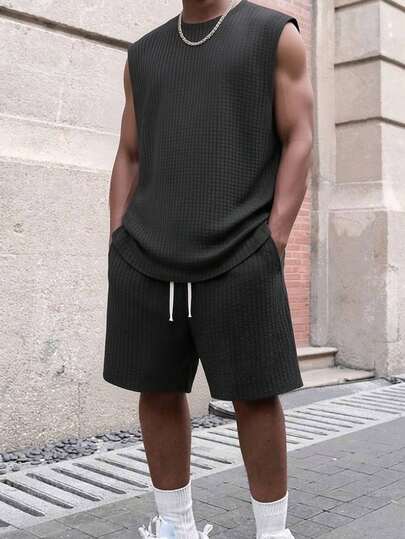 Bộ 2 món gồm áo tank top và quần short dệt kim kiểu waffle màu đen thoáng khí dành cho nam, kiểu dáng nghỉ dưỡng, chất liệu waffle co giãn, quần short thể thao chạy bộ, tập thể dục, đi biển thấm hút mồ hôi có túi.