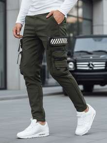 Pantalon de jogging cargo pour homme avec de multiples poches, taille et poignets élastiques, réglage par cordon de serrage, 8 poches, style tactique urbain, tissu extensible, coupe ajustée, poches latérales et détails fonctionnels. - Vert - Voir 1