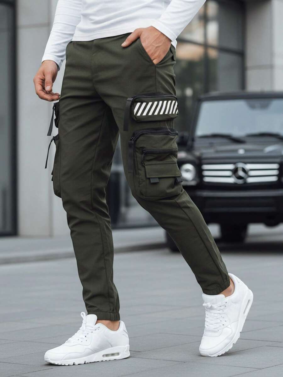 Pantalon de jogging cargo pour homme avec de multiples poches, taille et poignets élastiques, réglage par cordon de serrage, 8 poches, style tactique urbain, tissu extensible, coupe ajustée, poches latérales et détails fonctionnels. - Vert - Voir 1