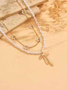 2件套奢华不对称仿珍珠串珠合金蝴蝶结花朵项链套装，百搭精致首饰，适合女孩，仿珍珠和花朵数量随机 - 彩色 - 查看 7