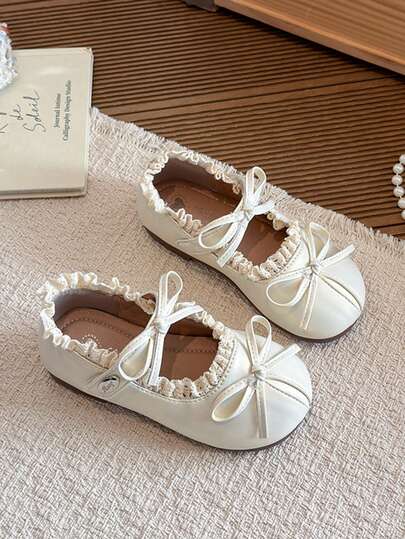 1双女童浅米色亮面PU底玛丽珍鞋，圆头设计，蕾丝鞋口，双蝴蝶结绑带，平底，温柔公主风，适合日常穿着、上学、生日派对等场合，2026年春夏款