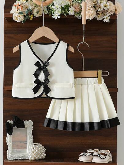 Conjunto de 2 piezas de niña pequeña con top de cárdigan sin mangas con cuello en V, moño 3D y falda plisada, un atuendo versátil y elegante para diario, fiesta y salidas en primavera/verano