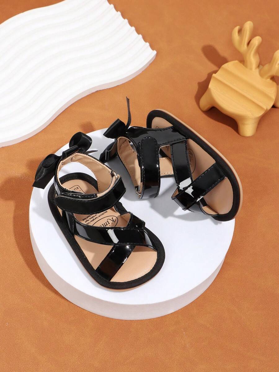 1 Pair Girls' Solid Color Bow PU Hook And Loop Design Flat Non-Slip Breathable Sandals, Toddler First Walking Shoes Suitable For Summer, 0-1 Years Old - Black - View 1