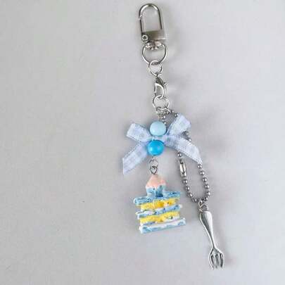 1 Stück Damen INS Stil handgemachte Gabel, blauer Kuchen, Schleife Perlen Charm, Handyband, Schlüsselanhänger