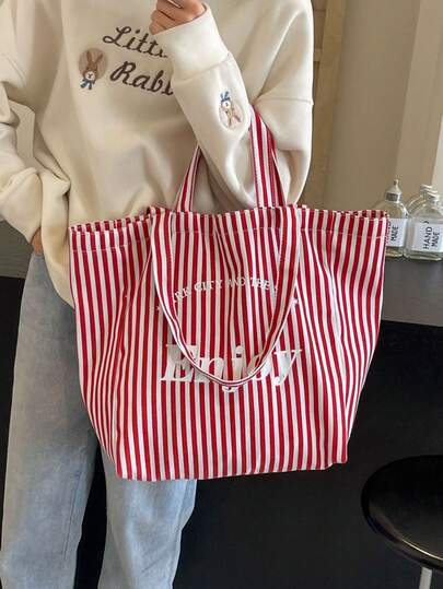 1个红白/黑白条纹+“Enjoy”字母印花帆布手提袋，大容量手提/单肩包，按扣闭合，简约韩版风格，适合学生、上班族、日常通勤和休闲外出。