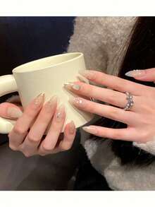 10片纯手工制作的中号杏仁形美甲贴片，以杏色为底，饰以金线、珍珠母贝小钻以及立体贝壳图案，点缀着小珍珠和小钻，呈现出精致低调的优雅气质。温柔优雅的可爱美甲，适合女士和女孩在春夏秋冬的各种节日、派对和日常生活中使用。 - 杏色 - 查看 3