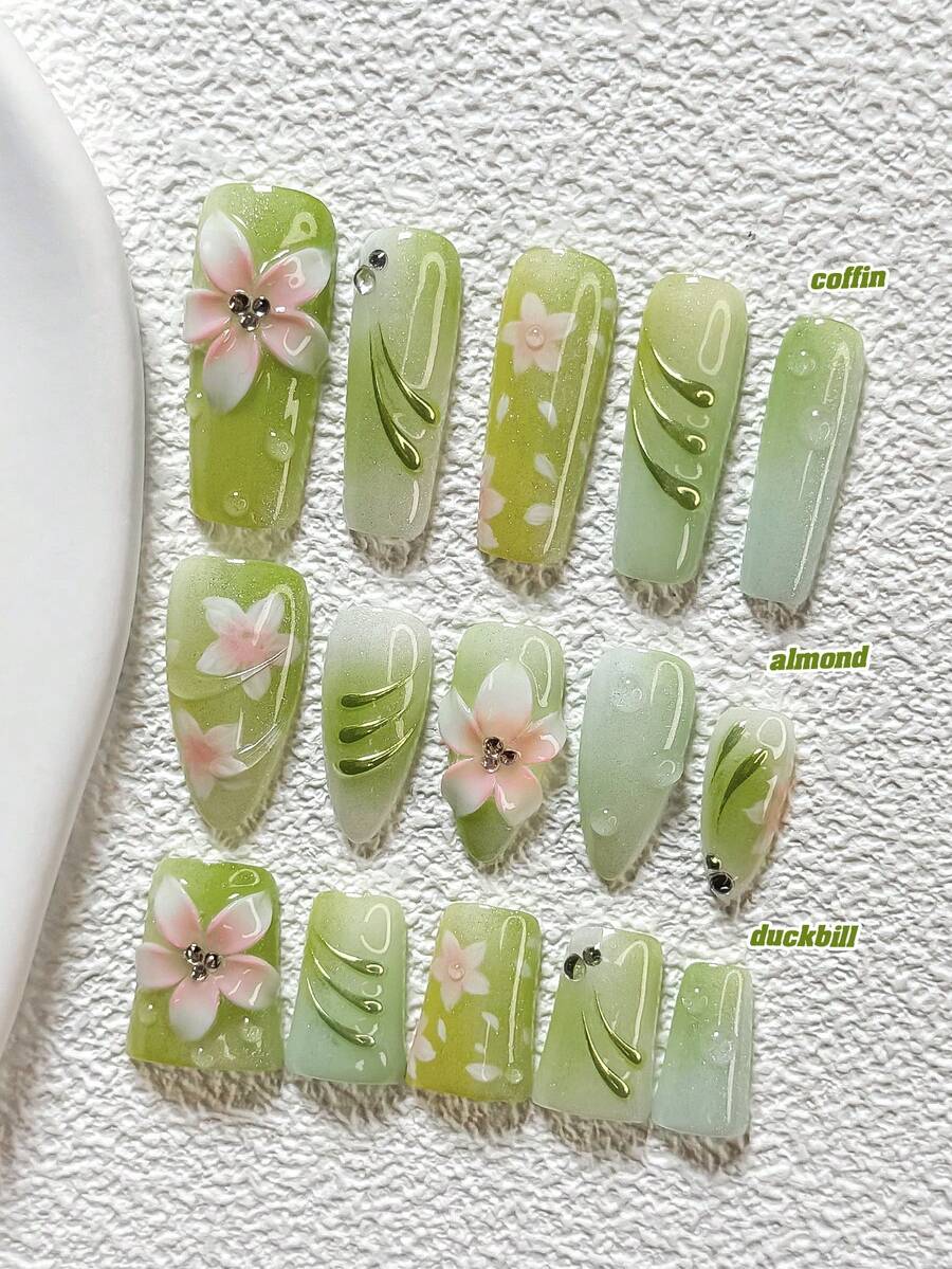10件套春日心情美甲套装，包含亚克力美甲贴纸、手绘渐变浅粉色五瓣花、绿色水波纹装饰、五瓣花朵美甲装饰、浅绿色猫眼指甲油，以及美甲工具（1张果冻贴纸+1把指甲锉），三种尺寸可选：杏仁形、鸭嘴形、棺材形。 - 彩色 - 查看 1