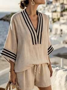 A Relaxed Two-Piece Summer Outfit For Women In A French Style – Featuring A Greek-Inspired V-Neck Top With Wide Sleeves And High-Waisted Shorts, Perfect For Casual Elegance And Comfort At The Beach - Beige - View 3