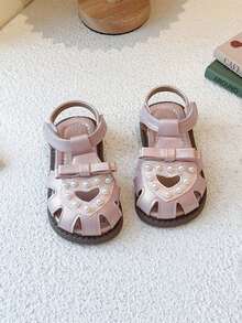 1 đôi dép xăng đan hình trái tim và nơ dễ thương cho bé gái, đế mềm chống trơn trượt. - Màu be - Xem 1