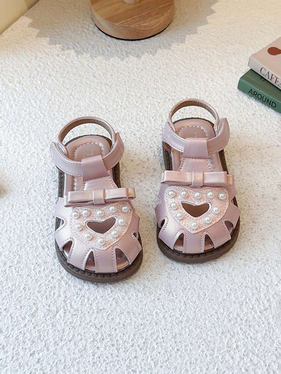 1 đôi dép xăng đan hình trái tim và nơ dễ thương cho bé gái, đế mềm chống trơn trượt. - Màu be - Xem 1