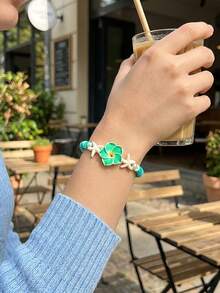 1 chiếc vòng tay hình hoa bằng đất sét mềm, có thể điều chỉnh kích thước, phù hợp cho nữ giới khi đi dạo phố, dự tiệc, đi biển và đeo hàng ngày. - Màu xanh lam - Xem 3